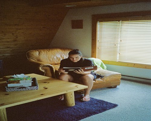 Person enjoying a book in a well-lit living room